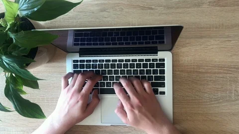 Hand of a man working at laptop computer typing on a keyboard on dark desktop. 스톡 동영상 107612064
