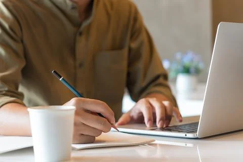Hand man writing notes workspace using a computer. communication and inform.. Stock Photos