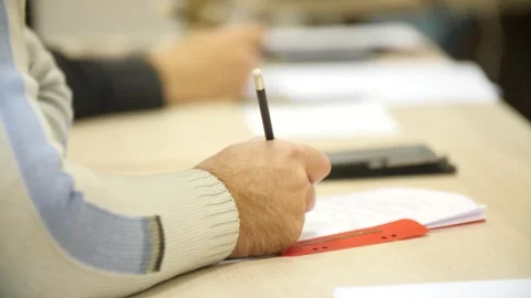 Hand of man writing pencil making notes on working meeting in office at table. 库存影片 257078147