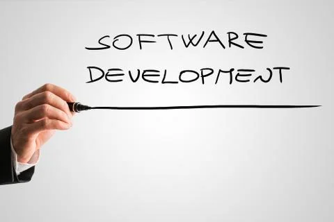 Hand of a man writing Software development on a virtual screen Foto stock