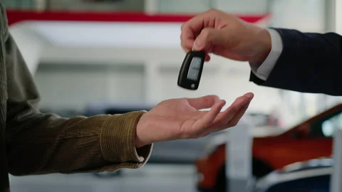 The hand of the manager who hands the keys to the buyer and shakes his hand Stock Footage 203768206