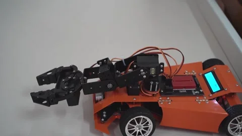 Hand manipulator. Robot car at an robotics lesson. Children's toy. Educational Stock Footage 258912574