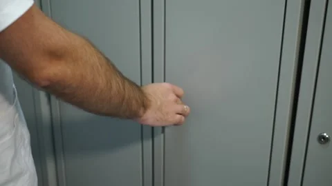  hand in a man’s white coat opens a personal locker Stock-Footage 130649043