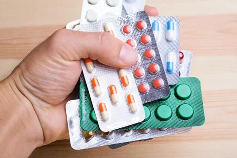 Hand with many different pills Stock Photos