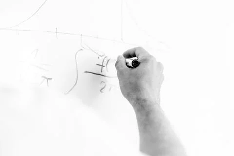 Hand with marker writing on board Foto stock