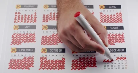 Hand Marking Days on Calendar with Pen in December, Counting Down to Event Stock Footage 317061502