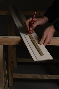 Hand marking measurement on panel board with folding ruler before cutting Stock Photos
