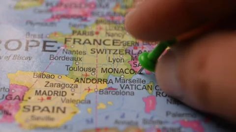 Hand Marking Monaco with Green Pin on World Map Stock Footage 333553427