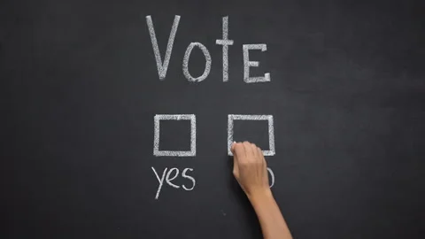 Hand marking no answer in vote written on blackboard, president election Stock Footage 113975407