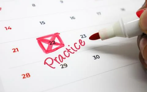 Hand marking Practice on a calendar date with a red marker, emphasizing imp.. Stock Photos