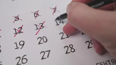 Hand marking a specific date on a calendar with a closeup view to emphasize Stock Footage 289308724
