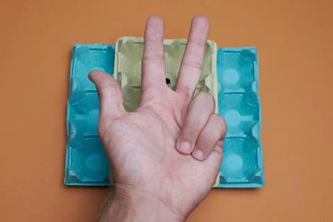 Hand marking three in orange background 写真素材
