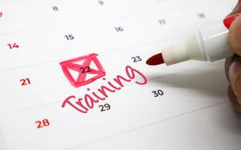 Hand marking Training on calendar with red marker. Concept of skill develop.. Stock Photos