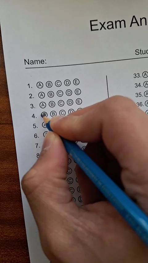 Hand marks a test with a blue pencil Stock Footage 330759987
