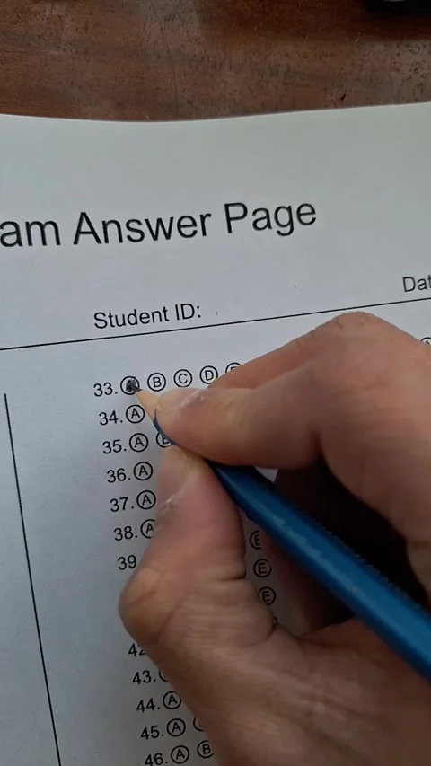 Hand marks a test with a blue pencil Stock Footage 330759992