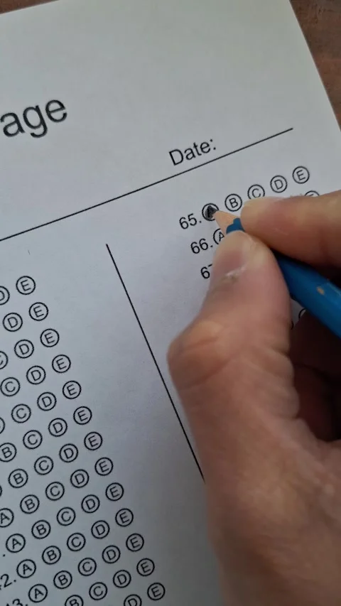 Hand marks a test with a blue pencil Stock Footage 330760013