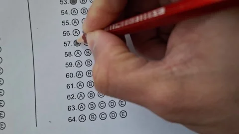 Hand marks a test with a red pencil Stock Footage 330760016
