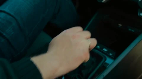 Hand of married man shifting automatic gear selector from park to drive in Stock Footage 311987615