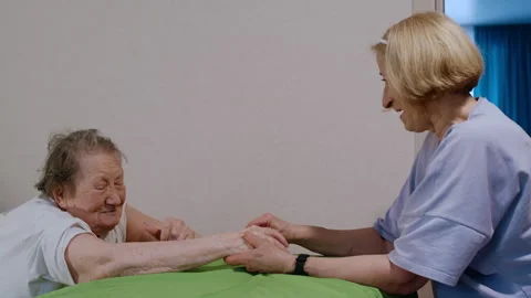 Hand Massage Session with Elderly Client and Professional Therapist Chatting Stock-Footage 311379514