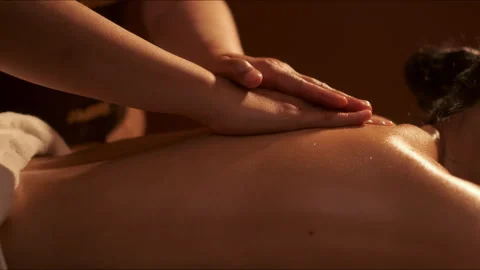 Hand of masseuse doing massage back with aromatherapy oil on back of a woma.. Stock Footage 241315815