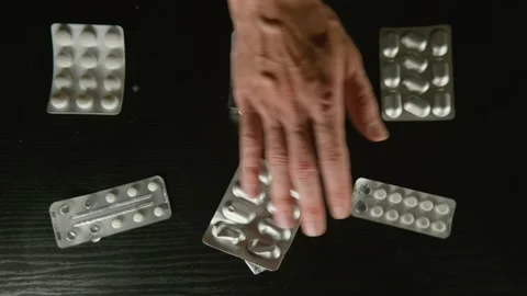 Hand with massive venes choosing the cure Stock Footage 200956795