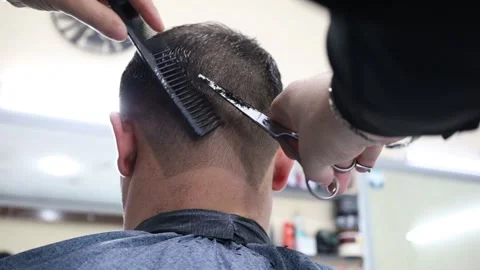 The hand of a master cuts hair with scissors. Stock Footage 299760933