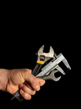 The hand of the master holds a set of tools for repairing plumbing Stock Photos