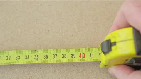 Hand of master or engineer who makes measurements using tape measure. Close.. Stock Footage 255289990