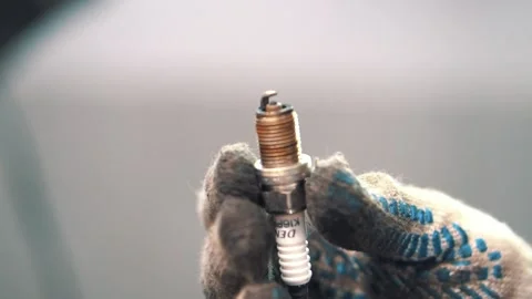 Hand of the master shows a car light bulb from different angles close up Stock Footage 153172295