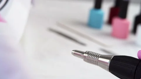 Hand of the master is taking out the milling cutter from the manicure machine Stock Footage 196223250