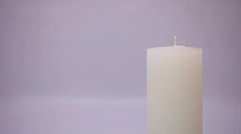 Hand with a matchstick lighting a candle Stock Footage 58310552