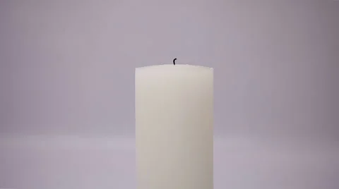 Hand with a matchstick lighting a candle Stock Footage 58311259