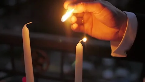 Hand with matchstick, lighting a candle Video stock 195166930