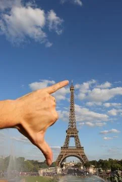 Hand that measures with the span the Eiffel Tower in Paris France Photos