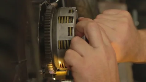 Hand of a mechanic screw some screws of a motorcycle clutch. Stock Footage 78222953