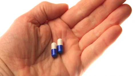 Hand with medicine capsules Stock Footage 32243463