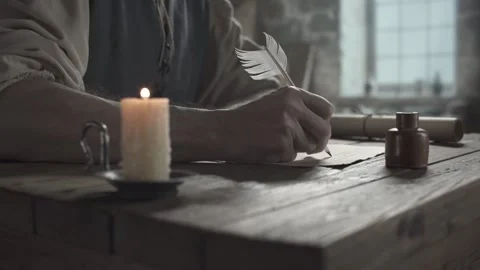 Hand of a medieval inventor writing cursive text with a quill pen Stock Footage 340322823