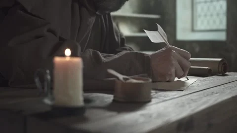 Hand of a medieval monk writing text on a parchment sheet Stock Footage 340079521