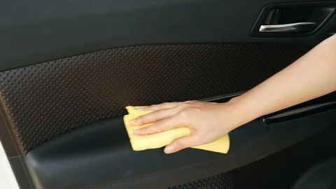 Hand with microfiber cloth cleaning interior car door panel Video stock 94533240