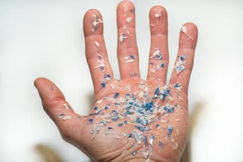 Hand with microplastics Stock Photos