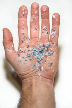 Hand with microplastics Stock Photos