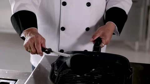 Hand of middle age man holding frying pan cooking food, professional chef w.. Stock Footage 245084232