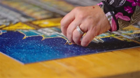 Hand Of A Middle-aged Woman Finishing A Puzzle At Home. Close-up Shot Stock Footage 337032353