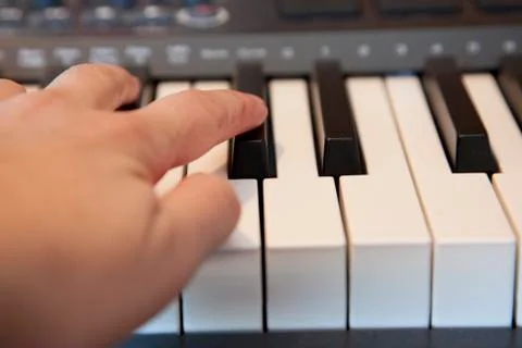 Hand on a midi keyboard Stock Photos
