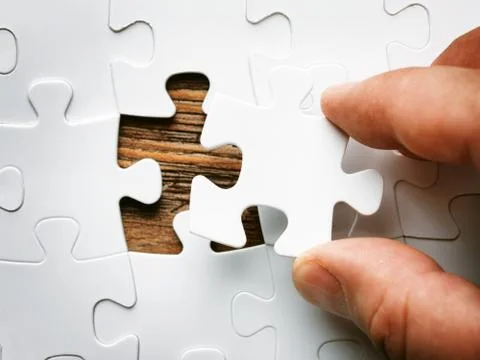 Hand with missing jigsaw puzzle piece. Business concept image for completing Stock Photos