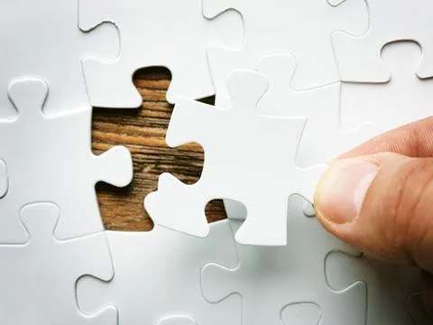 Hand with missing jigsaw puzzle piece. Business concept image for completing 写真素材