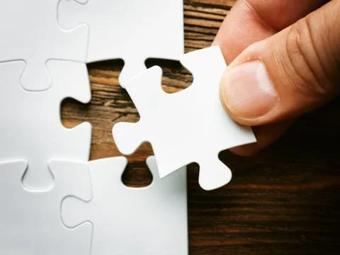 Hand with missing jigsaw puzzle piece. Business concept image for completing Stockfoto's
