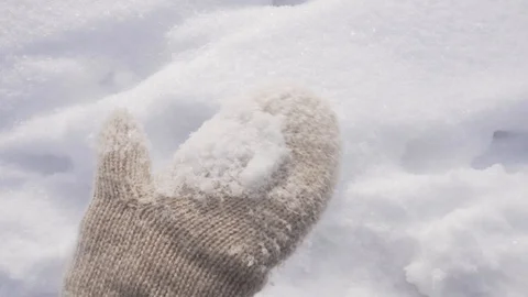 Hand in mitten touches snow Stock Footage 101017352