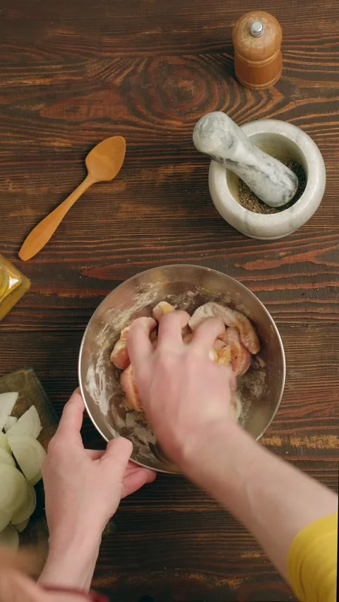 Hand mix sliced raw pork strips with corn starch and spices Stock Footage 345481304