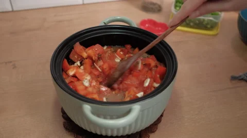A hand mixes meat with vegetables in a pan. Cooking healthy food at home Stock Footage 262430968